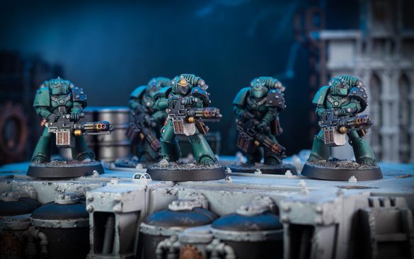 Cinematic shot of a Tactical Support Squad of five Sons of Horus with Rotor Cannons standing on a platform
