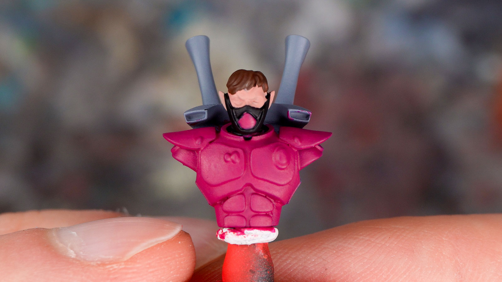 An Aeldari upper body painted as a demo model with Ionic Smart Colors, with details in pink, black, flesh tone, and brown