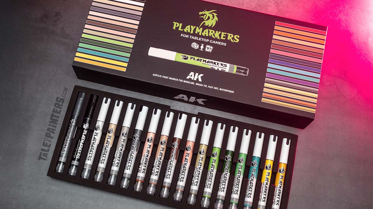 AK's Playmarkers complete set box, opened and arranged on a concrete background lit with pink light