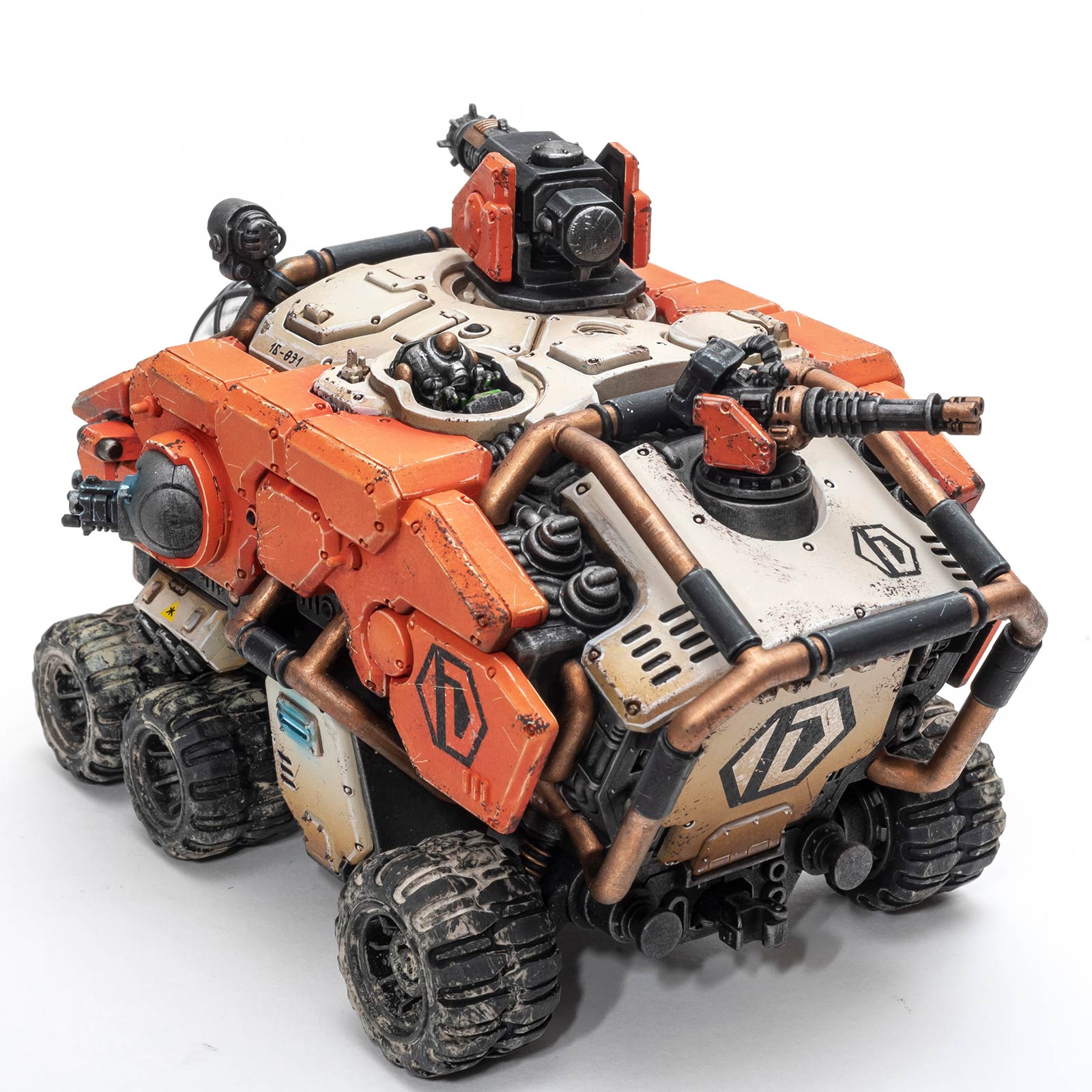 Back angle view of an orange painted Votann Hekaton Land Fortress by Dunk, photographed on a white background