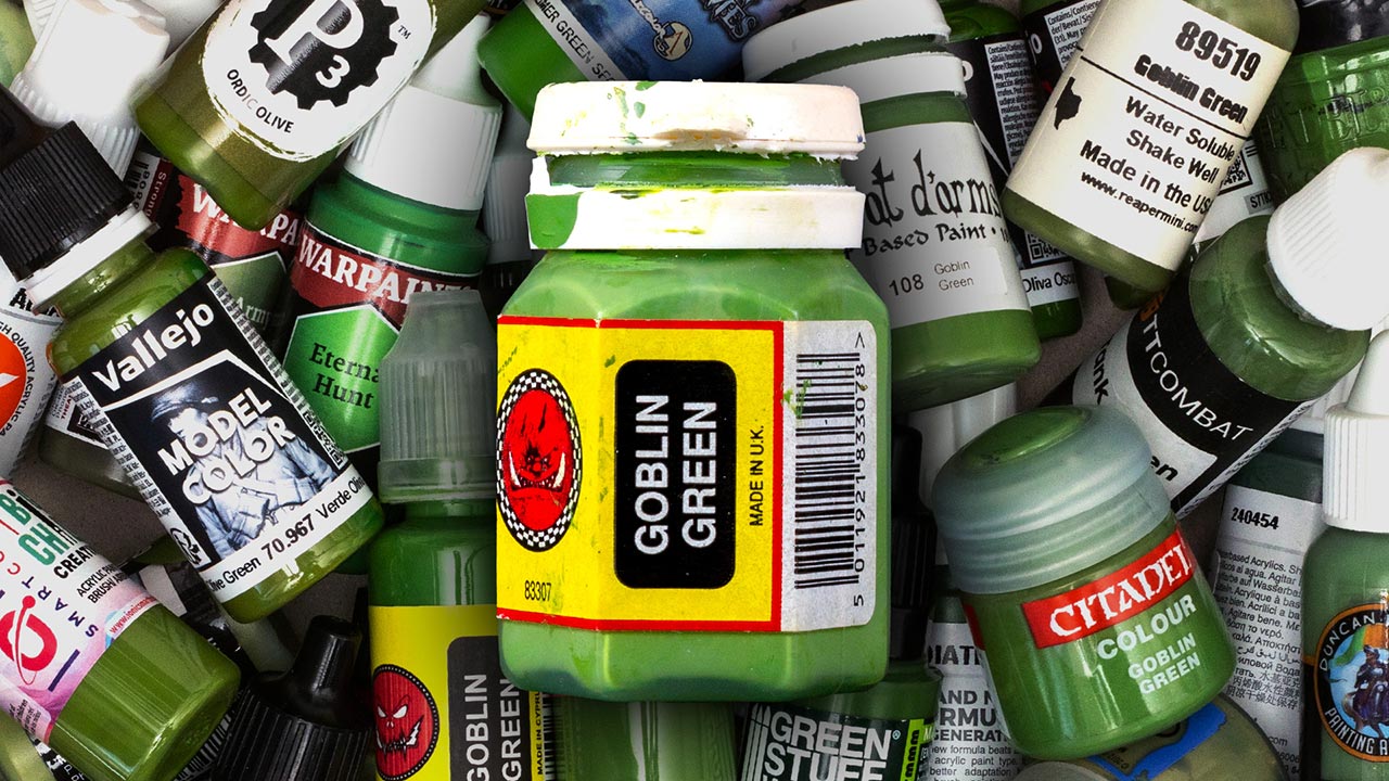 Montage of a pot of Citadel Colour Goblin Green from the 90s in front of various green Warhammer hobby paints