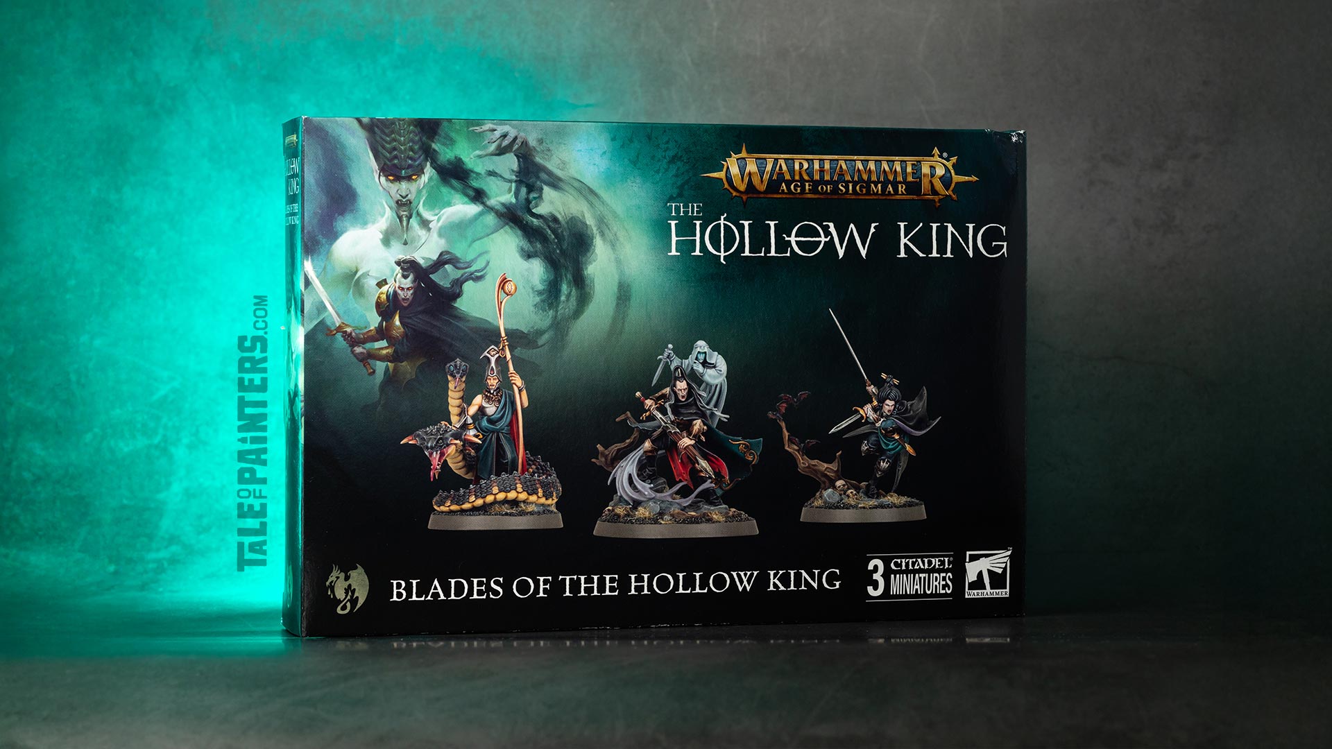 Blades of the Hollow King box on a concrete background, lit with turquoise light, photographed for review purposes