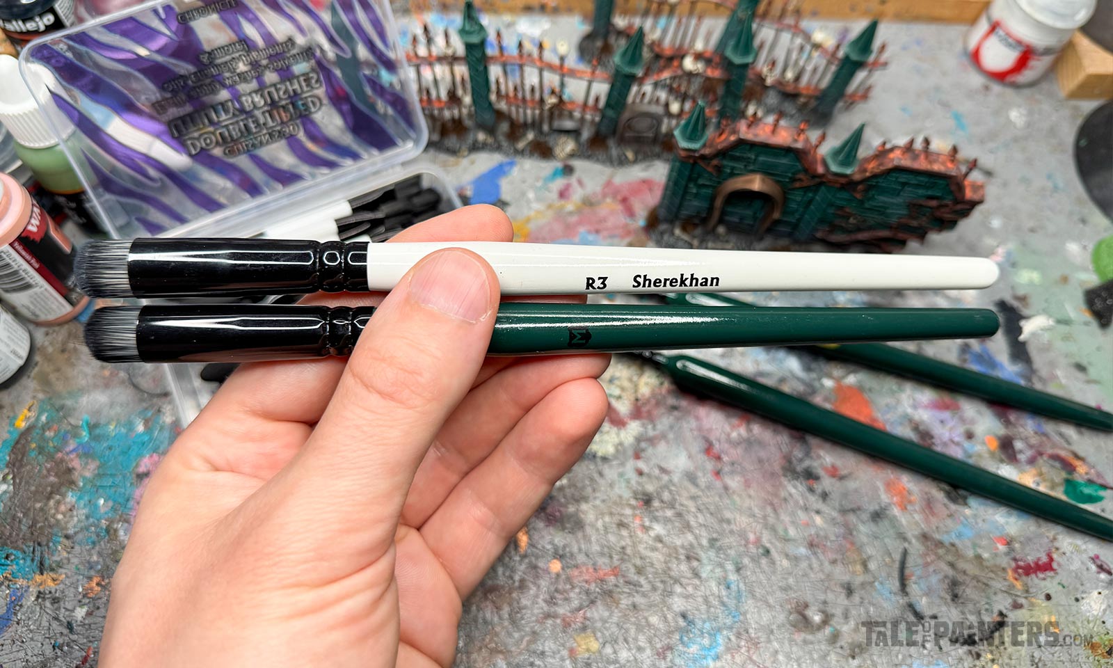 Hand holding both a Techlon Tiger and Chimera drybrush from Chronicle for comparison