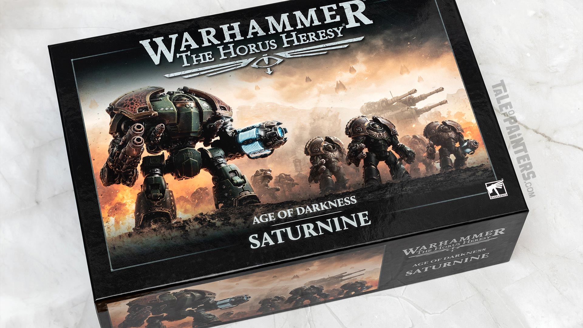 Horus Heresy Saturnine box arranged on a white marble background, photographed for a review and unboxing