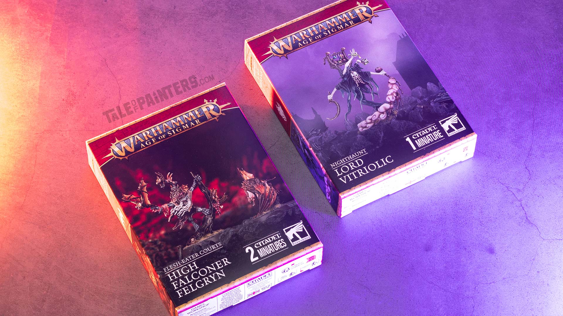 Nighthaunt Lord Vitriolic and Flesh-eater Courts High Falconer Felgryn boxes arranged on a concrete background, lit with red and purple light, photographed for review purposes