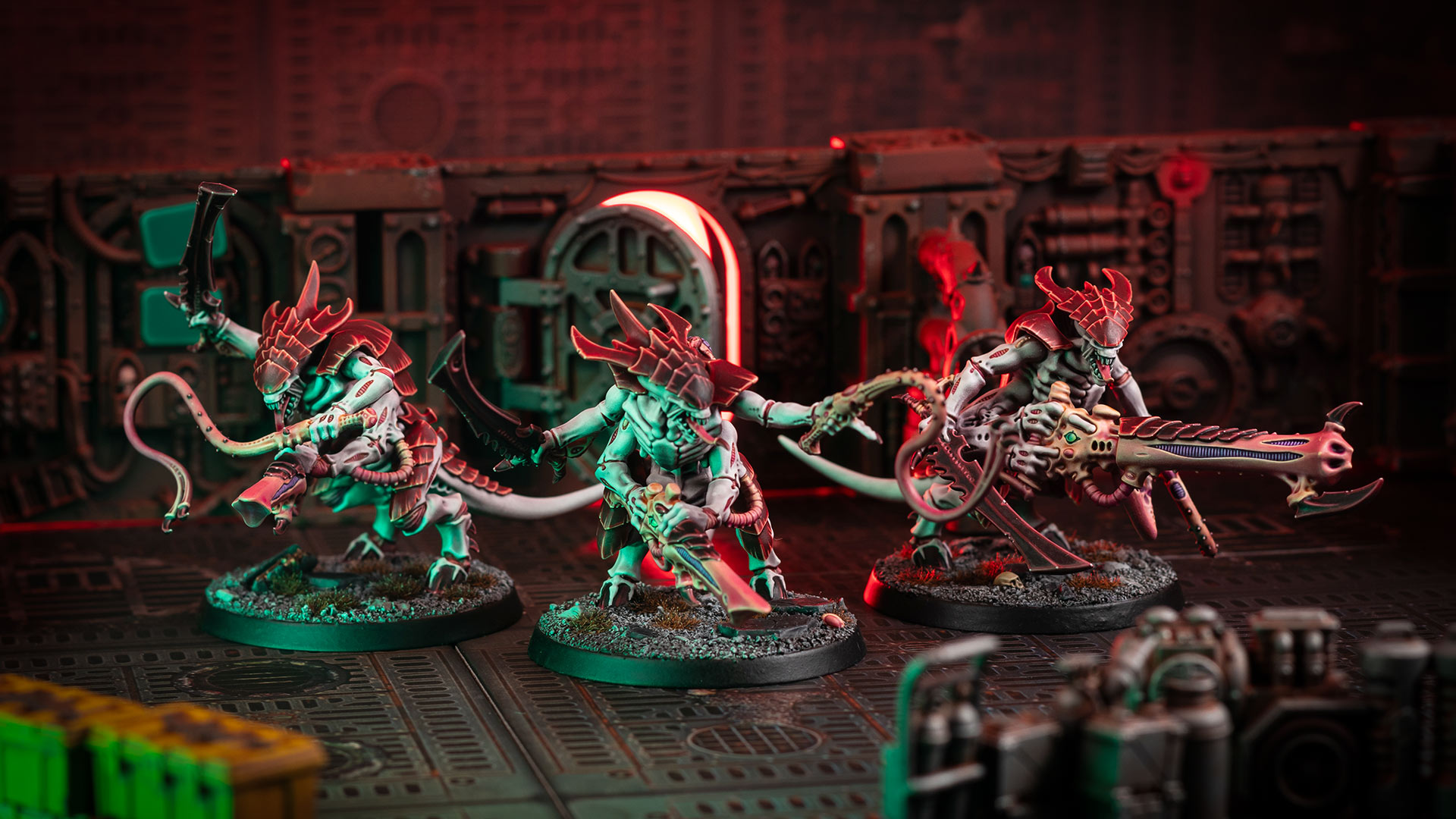 Cinematic shot of three Tyranid Warriors, painted in the bone and red of Hive Fleet Kraken, in a Gallowdark Space Hulk environment lit with red and green light