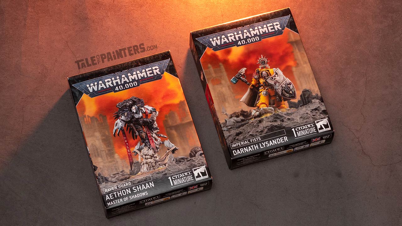 Raven Guard Aethon Shaan and Imperial Fists Darnath Lysander model kit boxes arranged on a concrete background, lit with orange light, photographed for review purposes