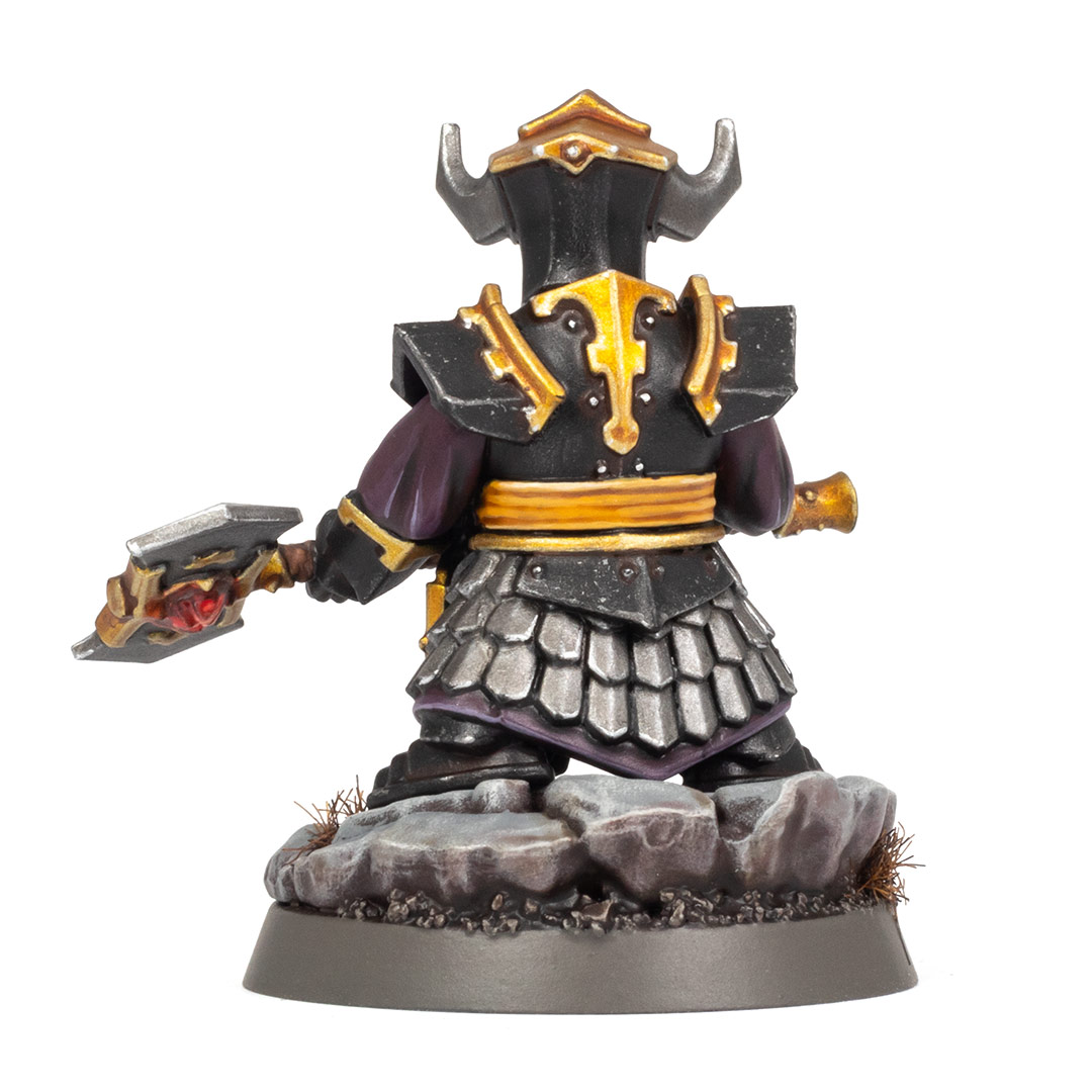 Back view of a Helsmiths of Hashut Infernal Cohort Championess painted in the black, yellow, and gold of Muspelzhaar by Stahly, on a white background