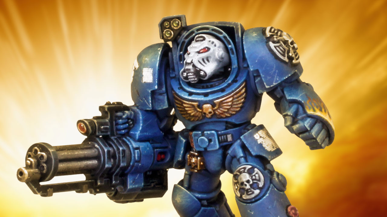 Cinematic shot of an Ultramarines Terminator with Assault Cannon in front of a dramatic orange explosion