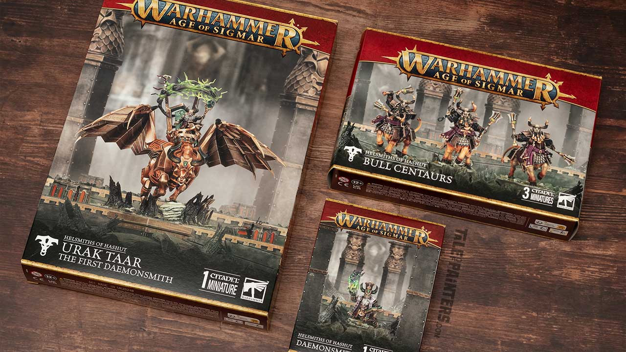 Helsmiths of Hashut Uruk Taar, Bull Centaurs, and Daemonsmith boxes arranged on a wooden background, photographed for review purposes