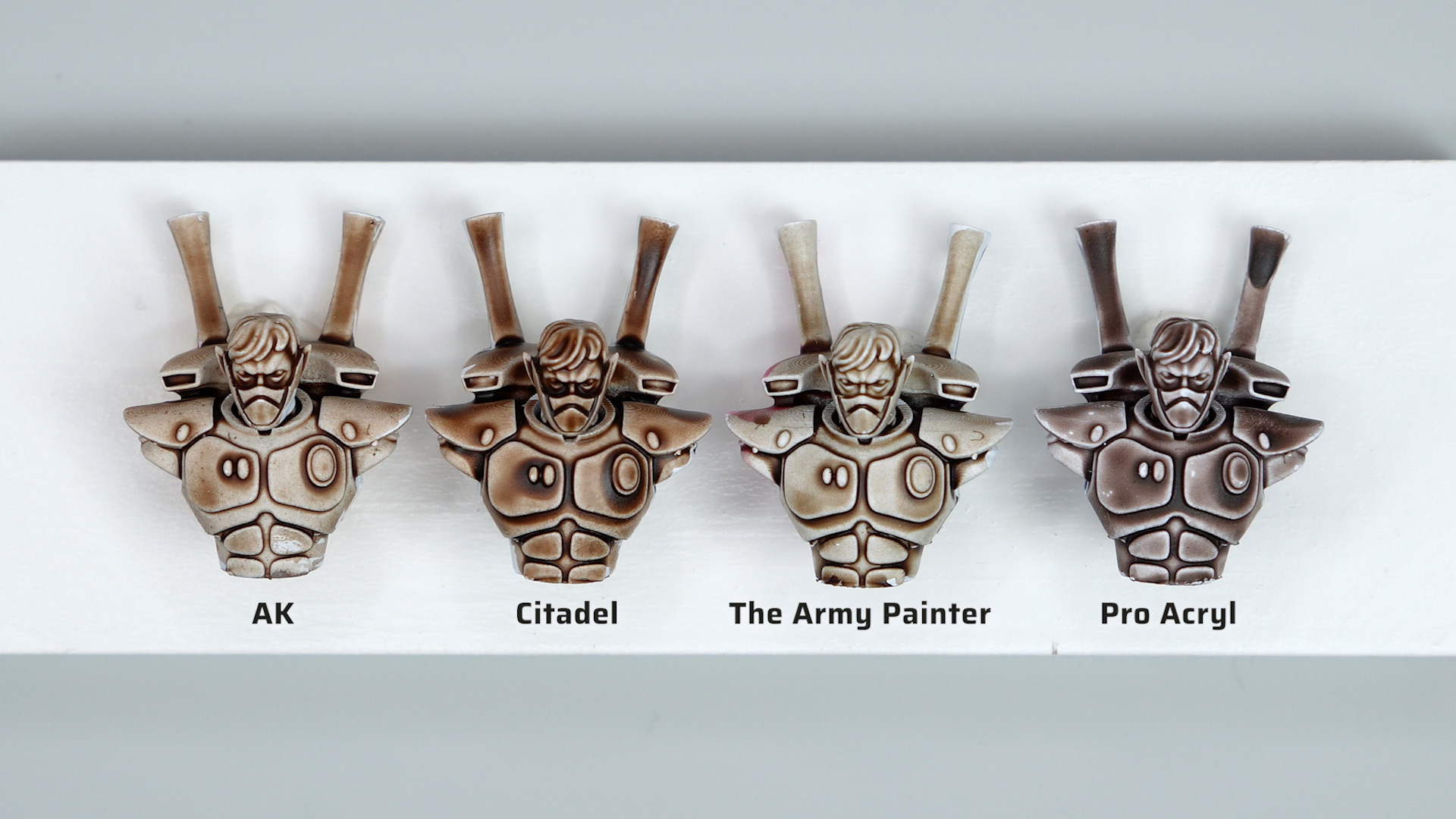 Comparison of AK Rotwood Brown wash, Agrax Earthshade, Warpaints Fanatic Strong Tone wash, and P3 Brown Wash, all applied over white primed Aeldari Guardian test models