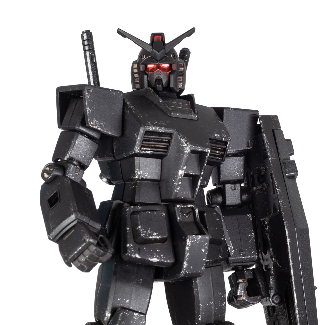 Close-up of the upper body of a Gundam RX-78-2 HQ Ecopla black model kit with weathering, on white background