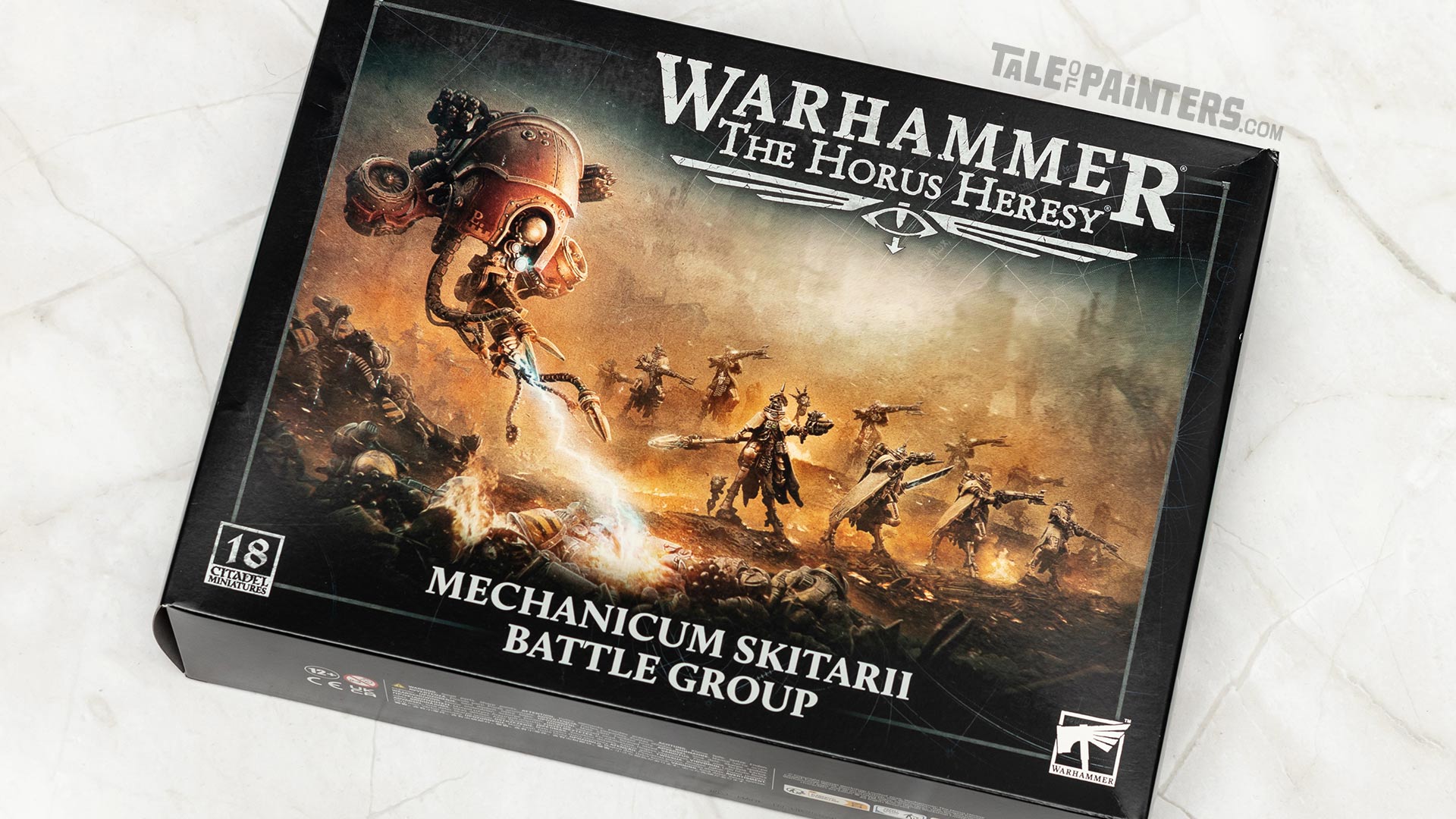 Horus Heresy Mechanicum Skitarii Battle Group model kit box arranged on a white marble background, shot for review purposes