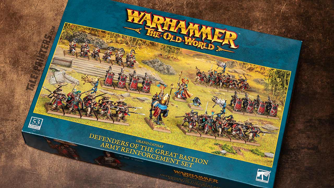 Grand Cathay Defenders of the Great Bastion Army Reinforcement box from Warhammer: The Old World, arranged on an aged brown leather background for a review and unboxing