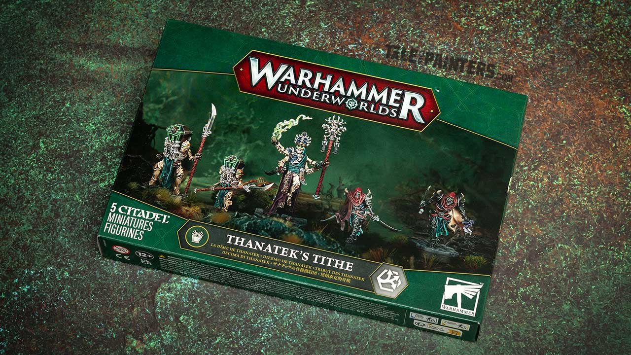 Thanatek's Tithe box from Warhammer Underworlds, arranged on a rusty dark green grunge background, shot for a product review and unboxing