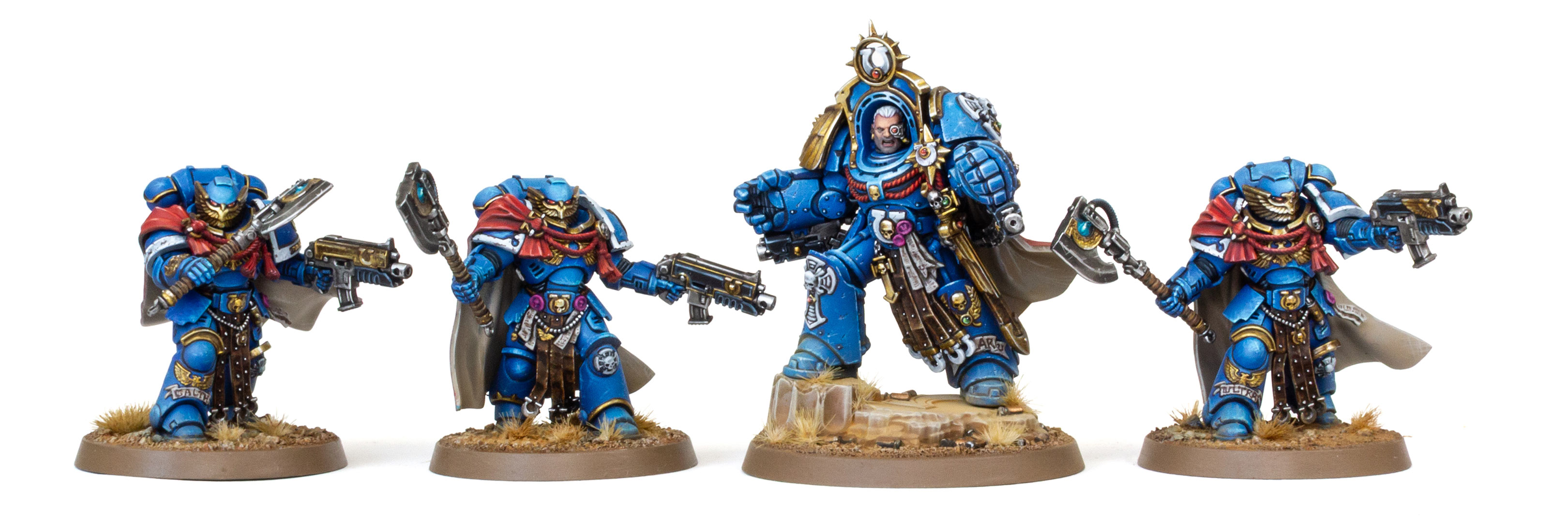 3 Ultramarines Victrix Guard and Marneus Calgar in the Armour of Antilochus, painted by Dunk, on a white background