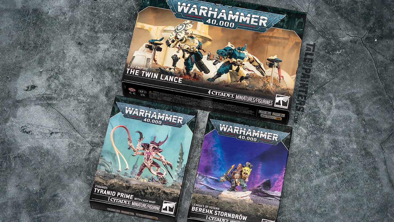 Warhammer 40.000 The Twin Lance, Tyranid Prime with Lash Whip, and Berehk Stormbröw model kit boxes arranged on a concrete background