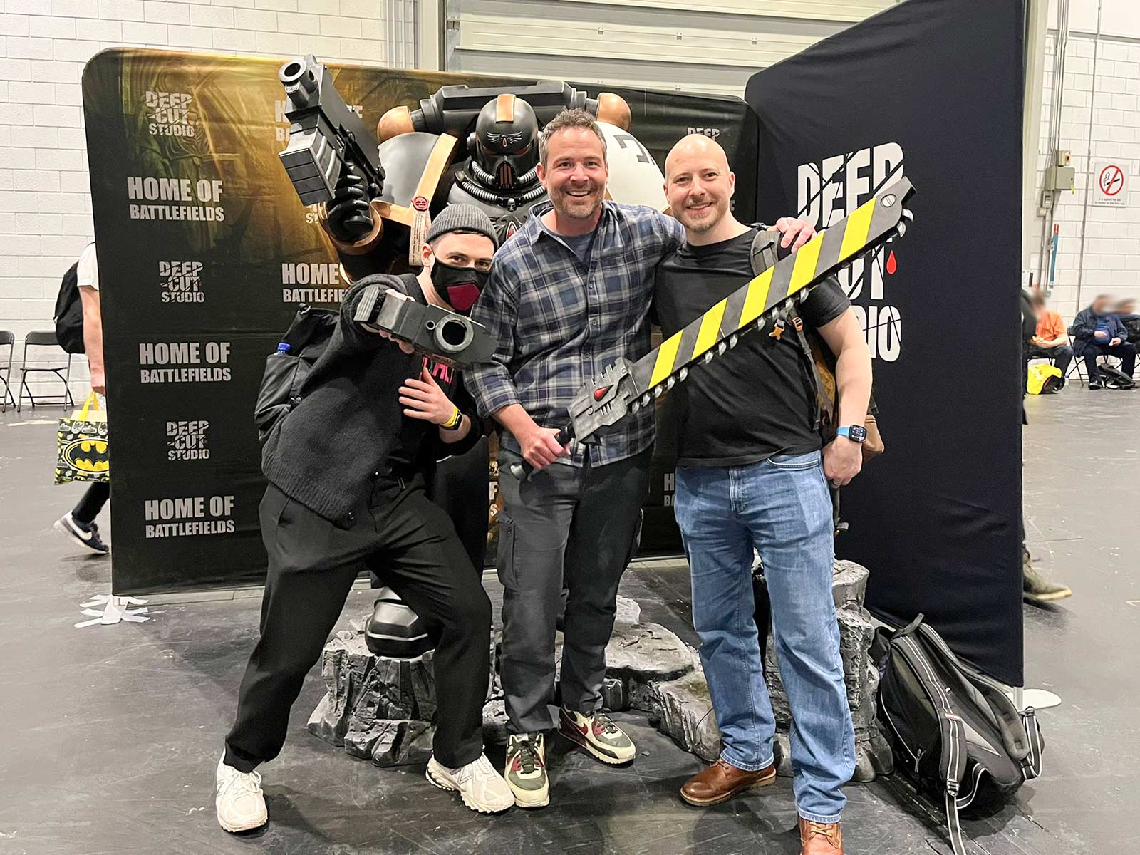 Stahly, Dunk and Garfy posing in front of a life-size Space Marine figure at Salute 53