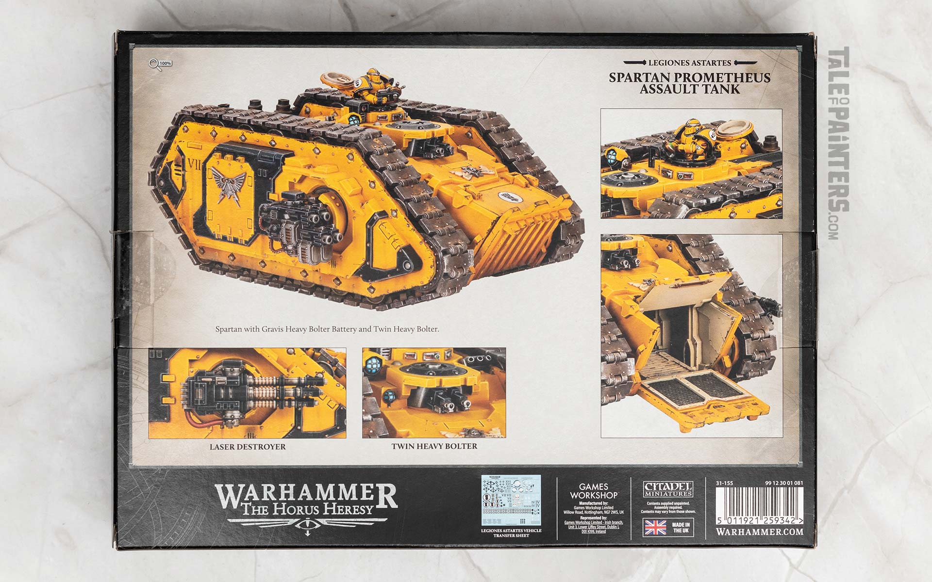 Back side of the Legiones Astartes Spartan Prometheus model kit box for the Warhammer Horus Heresy game, arranged on a white marble background