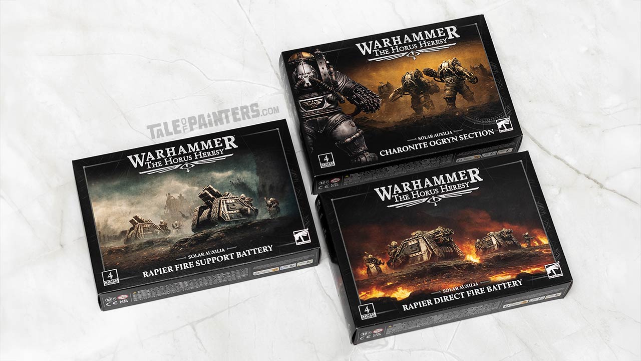 Solar Auxilia Rapier Fire Support Battery, Direct Fire Battery, and Charonite Ogryn Section model kit boxes for the Warhammer The Horus Heresy game, arranged on a white marble background