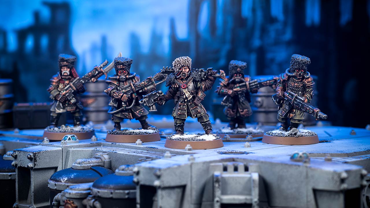 Cinematic shot of a Command Squad of five Vostroyan Firstborn, standing atop a plattform with blurry Sector Imperialis cityfight ruins in the blue background