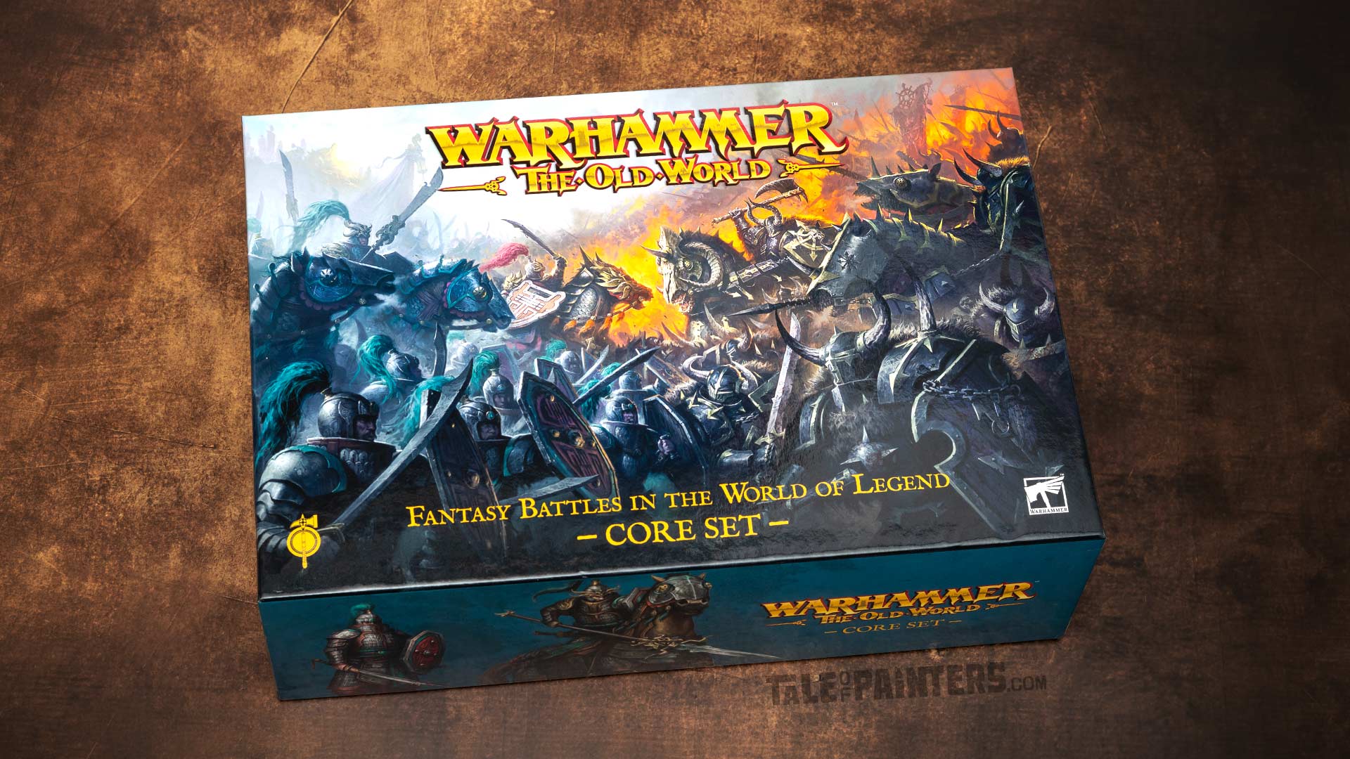 2026 Core Set box for Warhammer: The Old World, arranged on an aged brown leather background for a review and unboxing